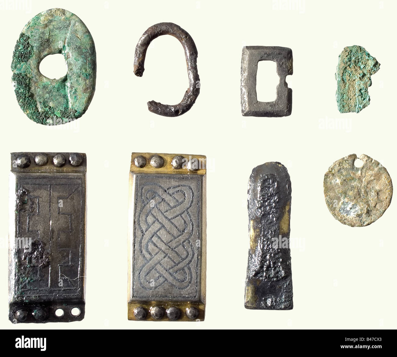 A set of weapons, Ancient Bavarian, 5th/6th century. A large spatha with caked on remnants of the leather-covered wooden scabbard. There are remnants of a cloth cover on the base of the blade (Byssus cloth?). Tang missing. Also fragments of a second sword blade, and an old-broken lance point with a slender ridged blade and a lightly ridged, conical socket with the attachment pin preserved. In addition, there are several mountings for a sword belt, including rectangular decorative pieces of gilded niello silver, a strap tongue, and a small buckle. Cleaned excava, Stock Photo