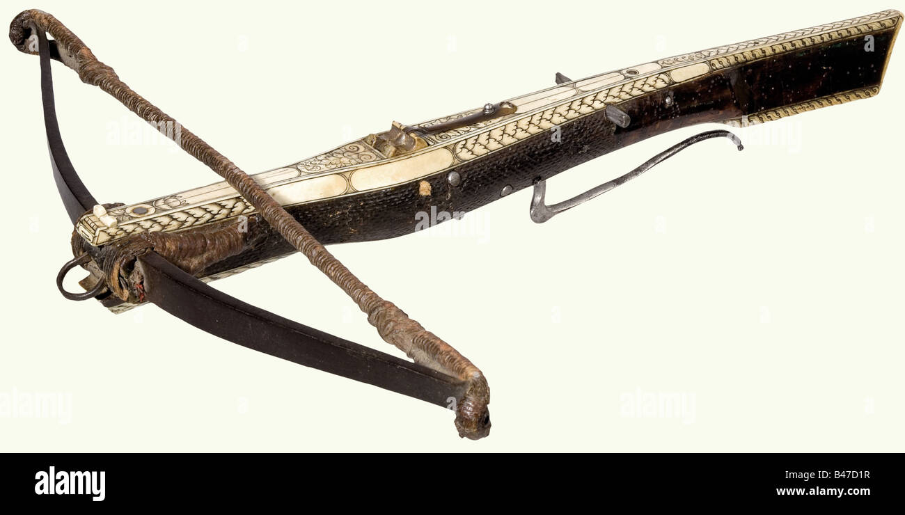 A German hunting target crossbow, circa 1600. Blackened iron prod with a smith mark stamped into one side. Cord anchor with an interwoven small iron ring. Proper twisted hemp cord. The walnut tiller, with worm damage in places, is richly covered with bone. The forward two thirds of the tiller have burl surfaces with finely engraved bone inlays on the top and bottom, a cord-mounted bone nut, and an original quarrel holder of dark horn. Lock has several axels. Folding trigger with an iron trigger bar. Length 56 cm. 17th century, crossbow, crossbows, distance weap, Stock Photo