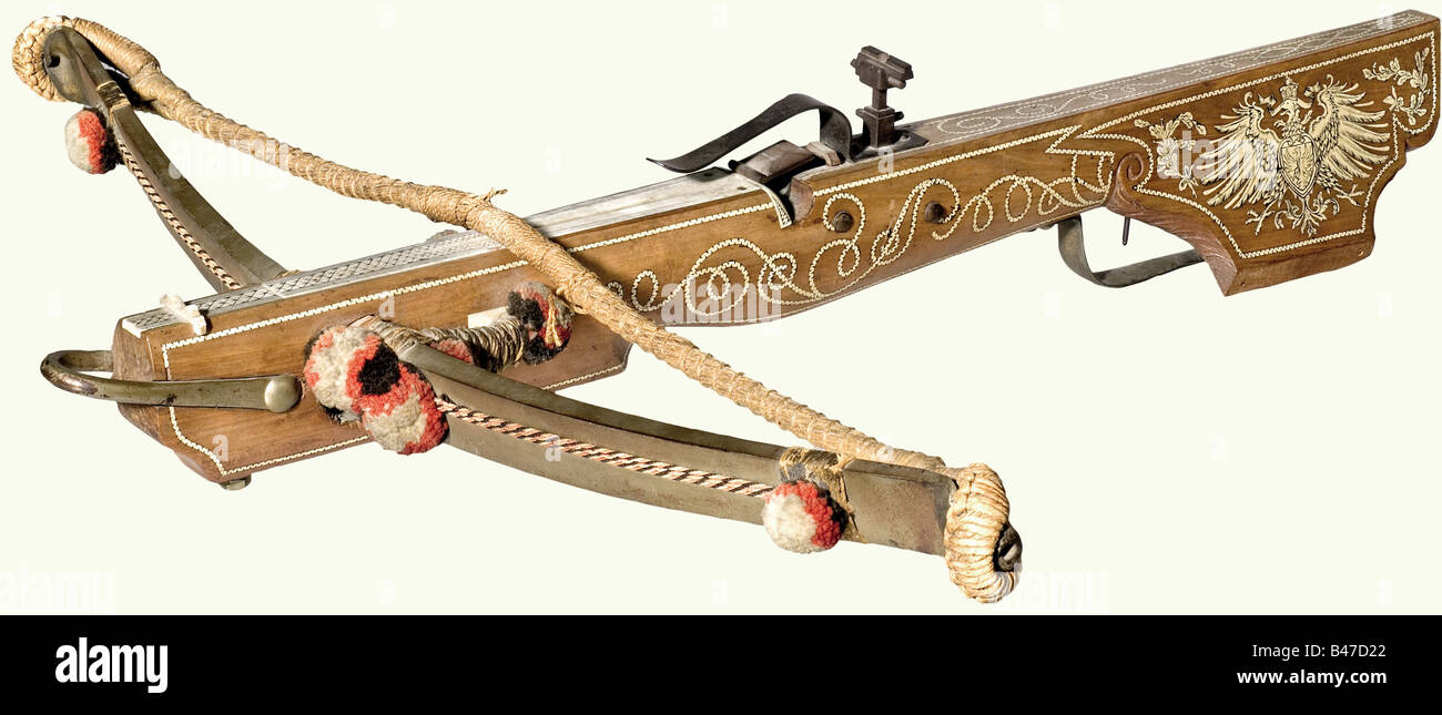 A German sporting crossbow, dated 1898. Massive steel prod with cord anchor, wool tassels, and twisted bow string. The fruitwood tiller has a slight belly and an engraved bone quarrel groove. There are vine-shaped inlays on the sides, and the cheek-piece is decorated with a German eagle. Dated '1898' on the underside. Iron nut, bolt clamp, sights, and trigger guard. Single set trigger. Length 77 cm. historic, historical, 19th century, crossbow, crossbows, distance weapon, weapons, object, objects, clipping, cut out, cut-out, cut-outs, Stock Photo