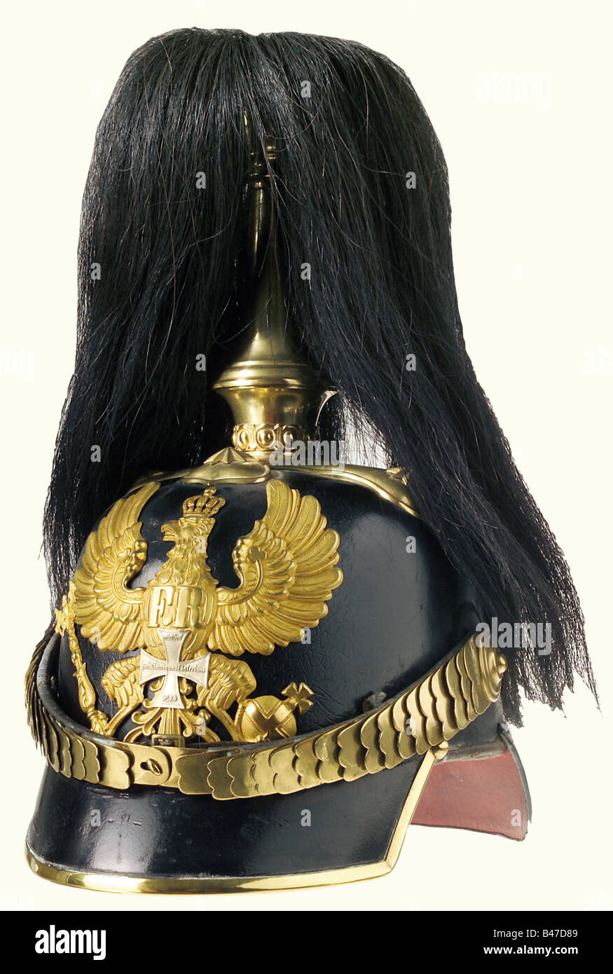 Prussia: A helmet of 1860 pattern for reserve officers, of the infantry. A well-preserved leather skull, with two assymetrically placed holes underneath the plate, and a slight dent on the rear peak. Gilt brass mountings, a plume holder with a black parade horsehair plume, and a frosted gilt plate overlaid with a reserve cross. Flat chinscales, and an officers' pattern state cockade on the right side. Red leather liner with slight traces of wear. Size 56. historic, historical, 19th century, object, objects, stills, clipping, clippings, cut out, cut-out, cut-out, Stock Photo