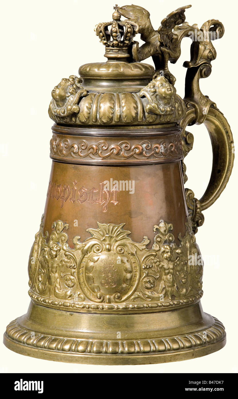 Archduke Franz Ferdinand of East Austria - a covered tankard from Konopischt., Massive bronze and brass tankard with the castle's name "Konopischt" engraved on the copper side, and the Archduke's crowned alloy monogram "FF" is on a relief-decorated scroll. Crowned lid with cupid heads and a decorative dragon. The interior is tinned. Height 25 cm. This piece comes from Konopischt Castle, the Archduke's summer residence in Bohemia. historic, historical, 19th century, Imperial, Austria, Austrian, Danube Monarchy, Empire, object, objects, stills, clipping, clipping, Stock Photo