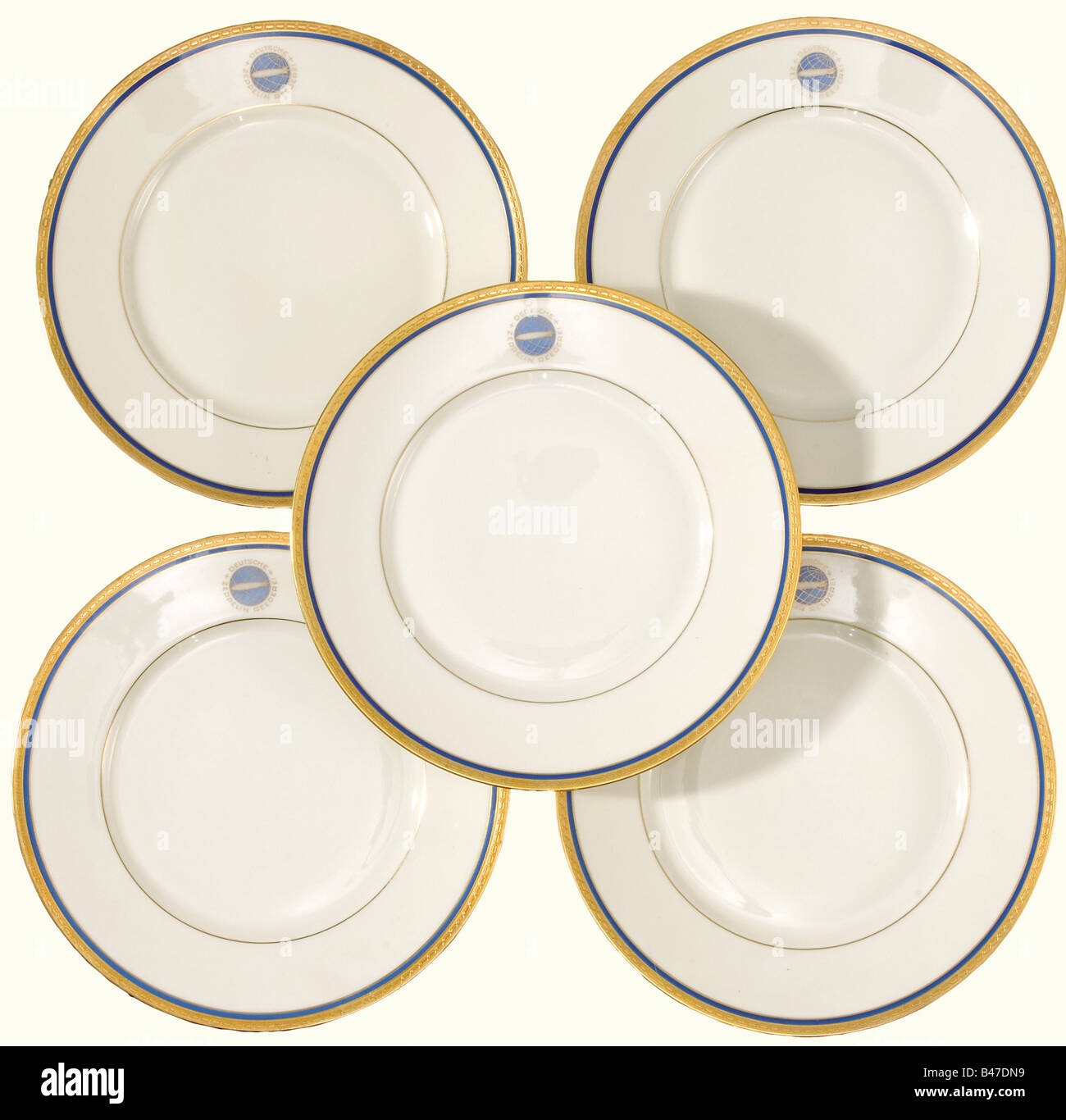 Six cake plates, from the German Zeppelin Shipping Line. Etched gold decorative rims set off with blue, and with the blue-gold emblem of the DZR (Deutsche Zeppelin Reederei) on the borders. Manufacturer's mark on the bottoms, 'Heinrich-Elfenbein-Porzellan Bavaria, Selb' and 'Eigentum der Zeppelin-Reederei' (Property of the Zeppelin Shipping Line). Diameter 20.3 cm. historic, historical, 20th century, transport, transportation, object, objects, stills, dishes, dish, plate, plates, porcelain, chinaware, Stock Photo