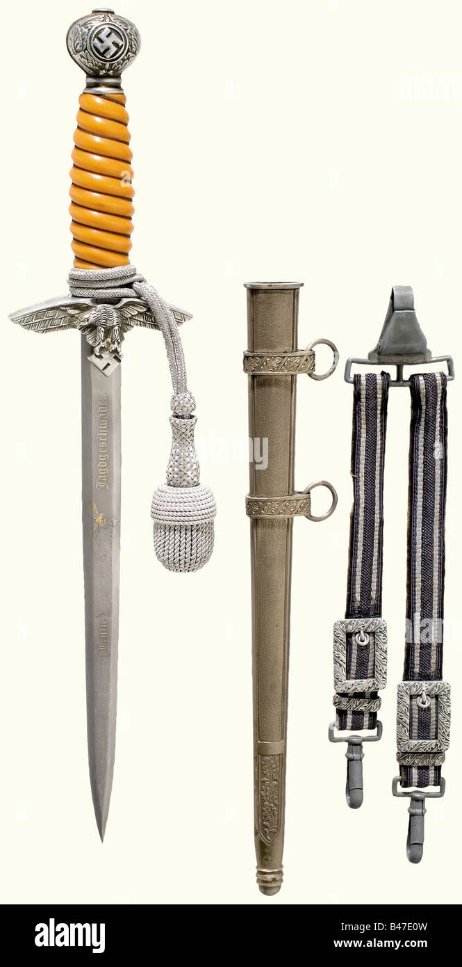 A dagger for a Luftwaffe officer, complete with hanger and sword knot. Blade with etched Damascus pattern bearing an eagle with remnants of gilding and the partially ground off dedication, 'Leutnant...Jagdgeschwader' (Lieutenant...Fighter Squadron)', 'Mit herzlichsten Glückwunschen zur Ritterkreuz-Verleihung' (With Heartiest Congratulations on the Award of the Knight's Cross). Made by 'Eickhorn Solingen'. Aluminium quillons and pommel, yellow plastic grip with wire winding. Silver-plated, iron scabbard. Length 39 cm.The breakup of an edged weapons collectionThe, Stock Photo
