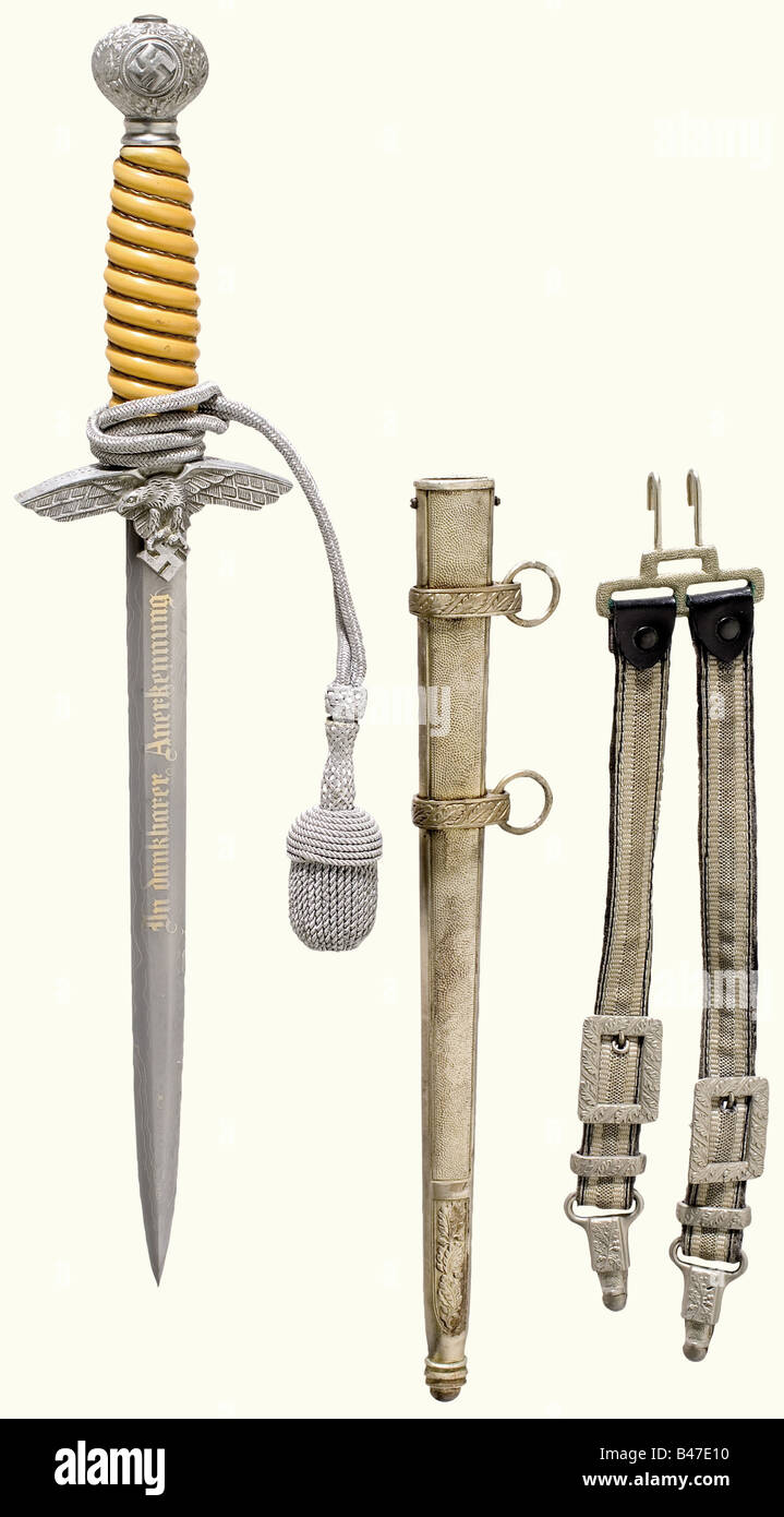A dagger for a Luftwaffe officer, complete with hanger and sword knot. Damascus blade with the etched and gilded dedications, 'In dankbarer Anerkennung' (In Grateful Recognition), as well as '31. Mai 1943 Hermann Göring' on the reverse side. Aluminium quillons and pommel. Orange coloured plastic grip with wire winding. Silver-plated, iron scabbard. Length 38.5 cm.The breakup of an edged weapons collectionThe pieces offered in this section of the auction were acquired since the post-war years from private possession or directly from the Solingen manufacturers, w, Stock Photo