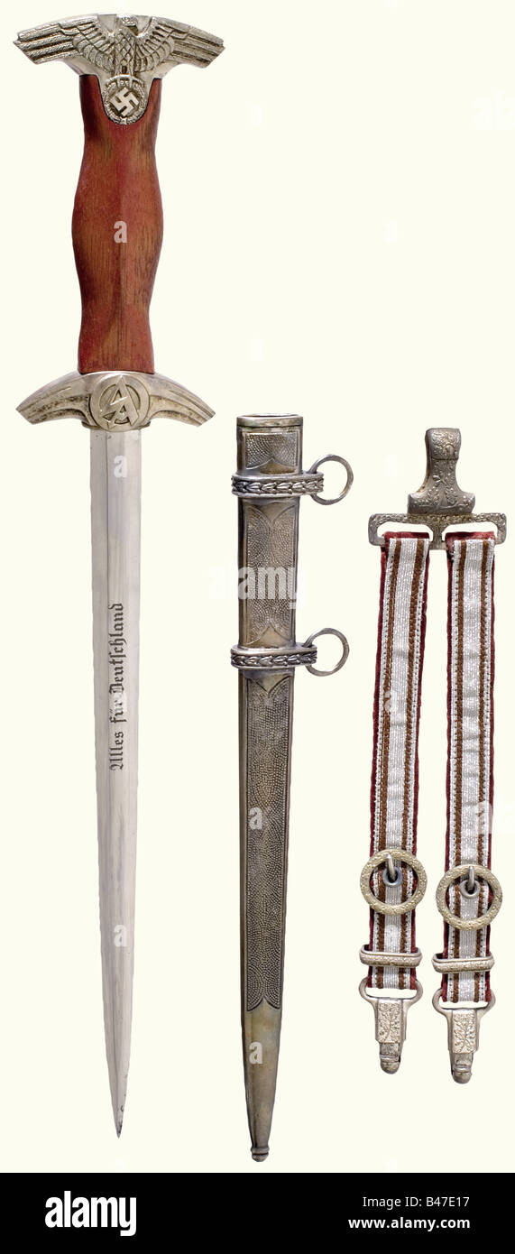 An SA Feldherrnhalle honour dagger, complete with hanger. Nickel-plated blade etched with the motto, and 'In herzlicher Kameradschaft - Viktor Lutze' (In hearty Camaraderie - Viktor Lutze) and the manufacturer's inscription, 'Eickhorn' on the reverse side. Silver-plated quillons and pommel. Brown wooden grip. Silver-plated scabbard. Length 44 cm.The breakup of an edged weapons collectionThe pieces offered in this section of the auction were acquired since the post-war years from private possession or directly from the Solingen manufacturers, who at the time pro, Stock Photo