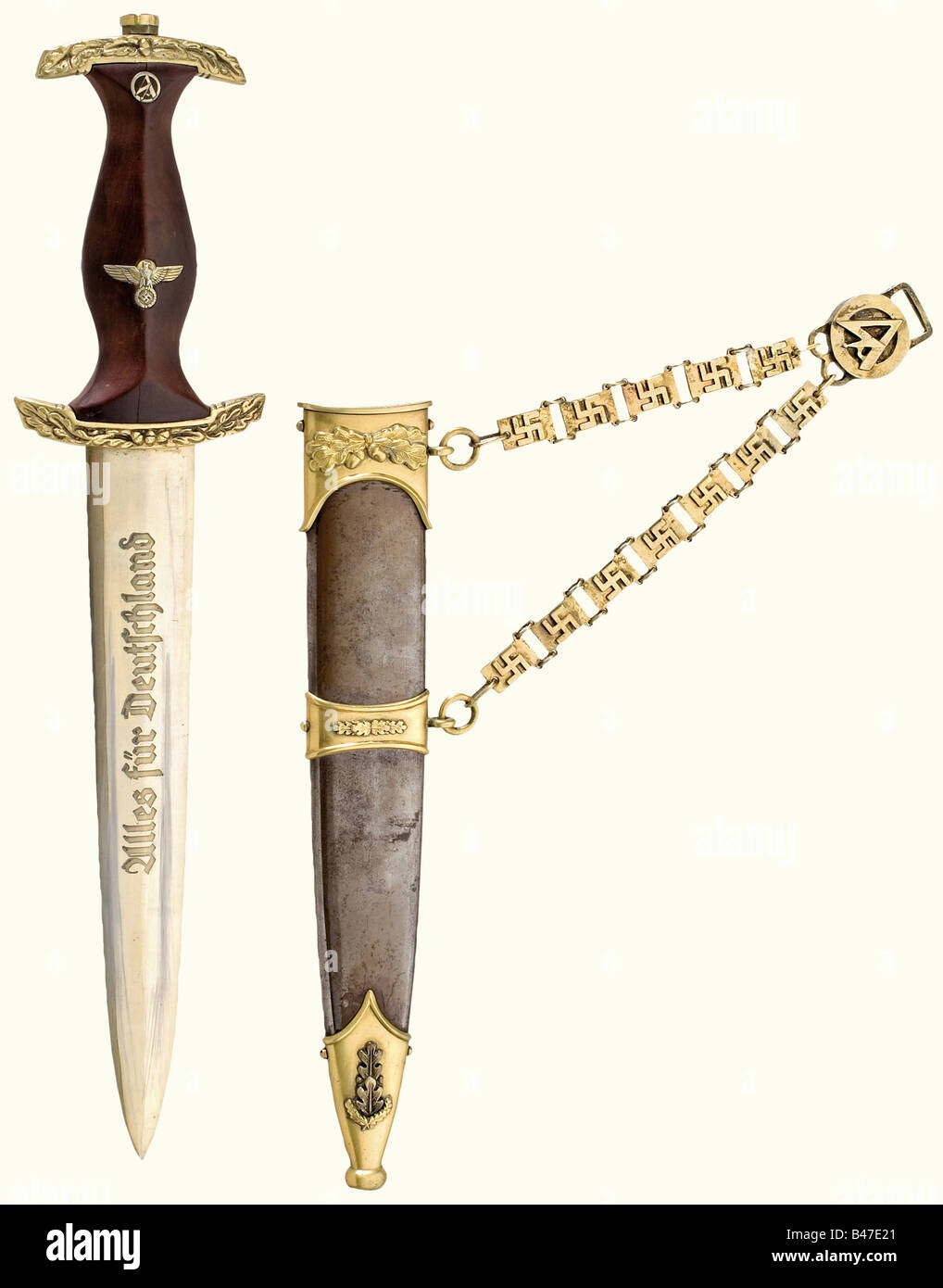 An honour dagger for the Naval SA., Blade etched with the motto and 'In treuer Kameradschaft - Viktor Lutze' (In loyal Camaraderie - Viktor Lutze) as well as the manufacturer inscription 'Clemens Jung Solingen'. Quillons with oak leaf decoration. Brown wooden grip (cracked). Browned scabbard, mountings decorated with oak leaves. Chain suspension. Blade and fittings gilded. Length ca. 35 cm.The breakup of an edged weapons collectionThe pieces offered in this section of the auction were acquired since the post-war years from private possession or directly from th, Stock Photo