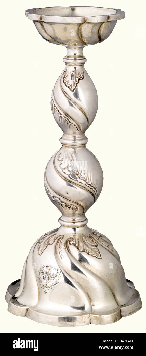 Hermann Göring, a silver candlestick in baroque style., Flaring bell-shaped base, the stem divided by three baluster and decorated with foliage in relief, large drip basin. On the viewing side the engraved Prussian eagle with swastika, in a laurel wreath with the inscription scroll 'Pro Gloria et Patria'. Silver hallmark '830' and master's mark. Height 35 cm. Weight 629 g. Provenance: 'Ehemaliger Besitz von Hermann Göring im Namen und für Rechnung des Freistaates Bayern', Neumeister, Munich, 25 October 1974, lots 3233 to 3237 pictured in the auction catalogue, , Stock Photo