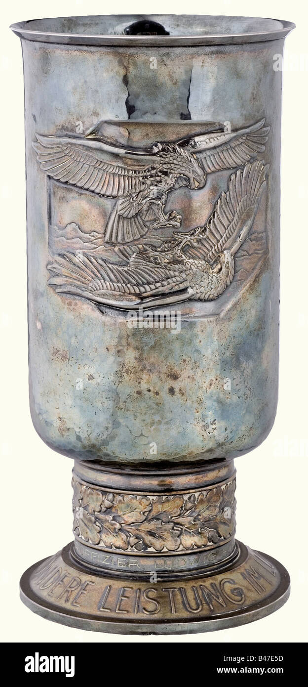 A goblet of honour for outstanding performance of duty in aerial combat, to 'Unteroffizier Ludwig Schätzel am 20.10.42'. Silver plated (tarnished), nickel silver version marked (transl.): 'Nickel silver with fine silver plating' and 'Joh. Wagner & Sohn' on the bottom. The inscription ring with engraved dedication. Height 20.5 cm. Weight 401 g (OEK 4025). Included is a 2003 photo expertise by Detlev Niemann.' historic, historical, 1930s, 1930s, 20th century, awards, award, German Reich, Third Reich, Nazi era, National Socialism, object, objects, stills, medal, d, Stock Photo