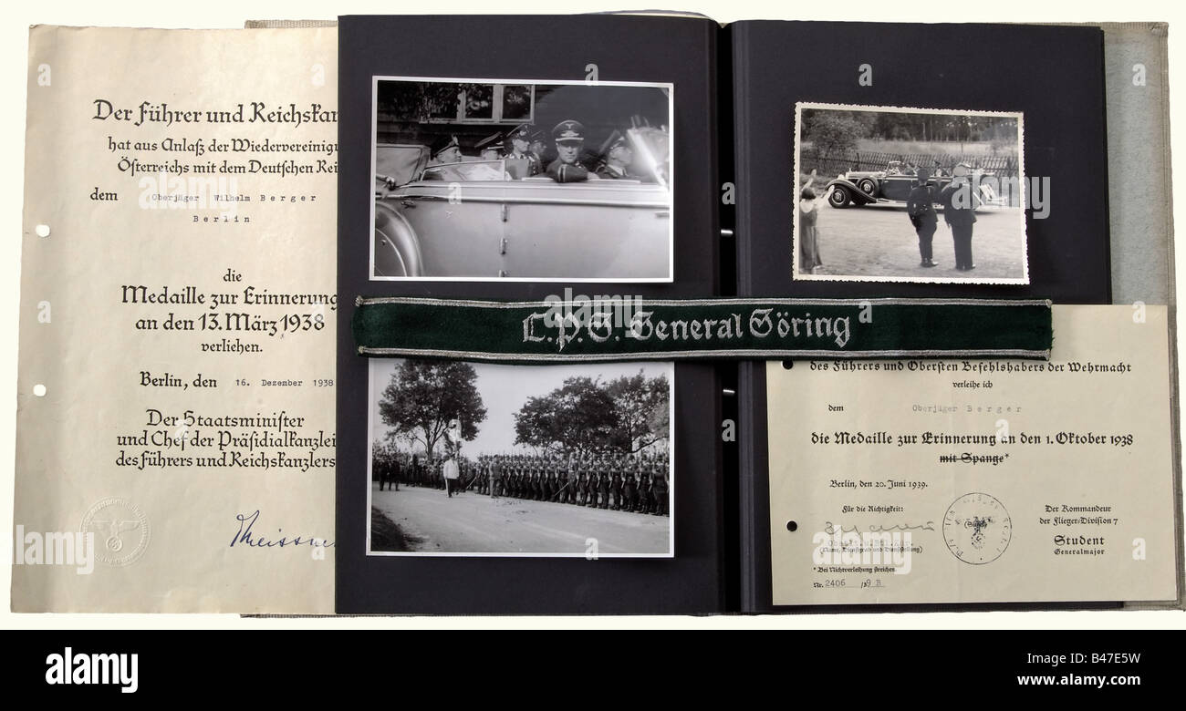 Oberjäger Wilhelm Berger, documents, photos, and officer's version (35.5 cm) of the sleeve band for the Regional Police Group 'General Göring'. Citations for the 13 March 1938 Medal and for the 1 October 1938 Medal. Order of 1 April 1941, promoting him to Feldwebel, and a 1943 order assigning him as an Assistant Instructor. Album of memoirs with a bound in programme for the Christmas Celebration of 1937, and a four page typed chronicle in the form of a poem. In addition 32 photos of training, Hitler and Göring, Göring and Mussolini, Carinhall, Honour Company, g, Stock Photo