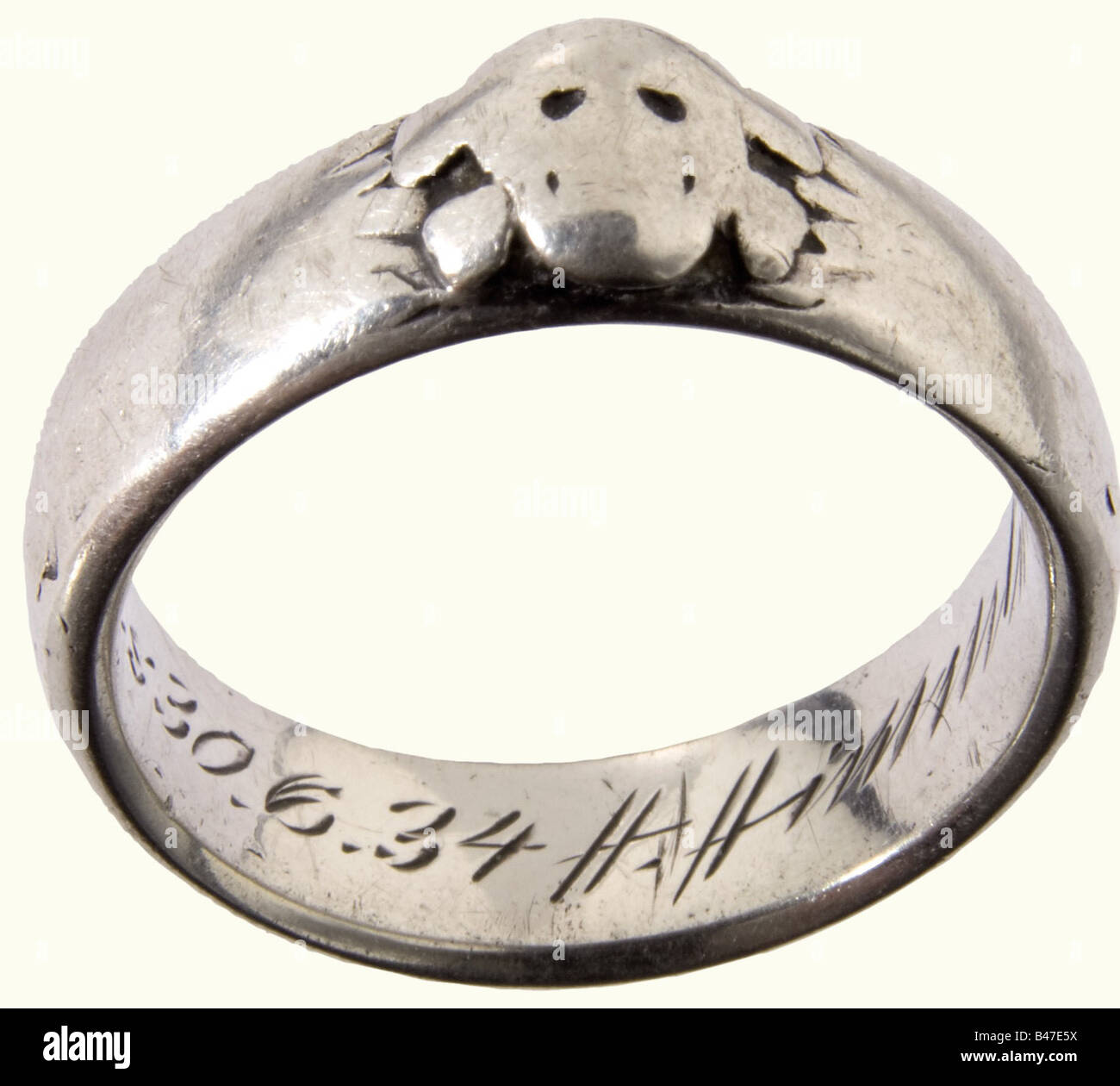 SS-Obersturmbannführer Emil Büchs - SS Death's Head Ring, and three documents. The ring is worn smooth, with identifiable superimposed Death's Head and the engraved dedicatory inscription 'S.lb. Büchs 30.6.34 H. Himmler'. Included are the award documents for the Honour Cross for Front Fighters 1935 to the 'Referenten bei der Reichsführung der SS' ('Consultant to the Reichs SS Leadership') and the War Merit Cross 2nd Class with Swords 1941 with signature in ink of Major General and Wehrmacht Commander in the East Walter Braemer, as well as the transmittal letter, Stock Photo