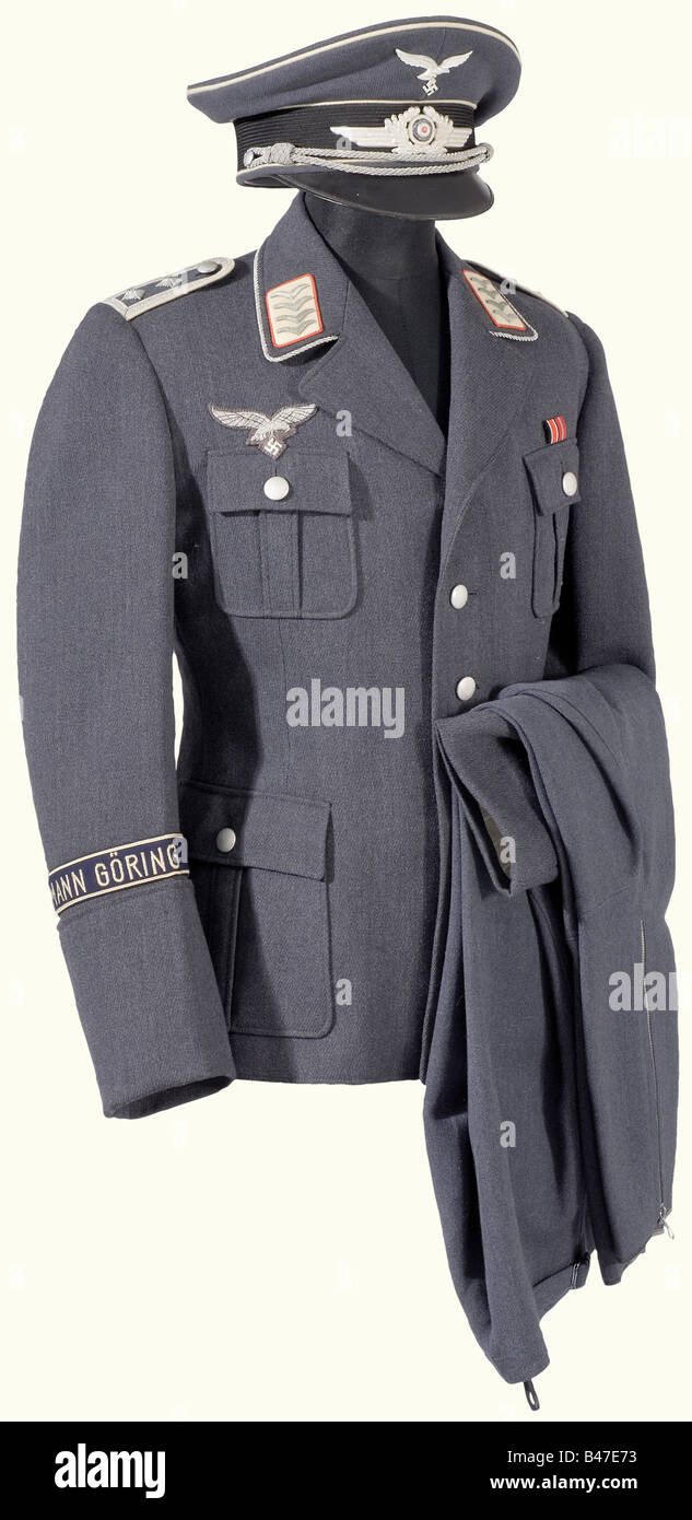 A walking-out uniform for an Oberfähnrich (Officer Candidate), of the Artillery Battalion of the 'Hermann Göring' Regiment. Visor cap of Luftwaffe blue gabardine with black mohair cap band and white piping. Aluminium insignia, silver cord, grey silk lining with manufacturers label 'L.V.A. - Verkaufsabteilung der Luftwaffe - Berlin'. (L.V.A. - Luftwaffe Sales Division- Berlin). Tunic of Luftwaffe blue gabardine, silver buttons, collar with surrounding silver lace and white collar patches with red piping. Sewn-on shoulder boards with white piping. Embroidered sil, Stock Photo