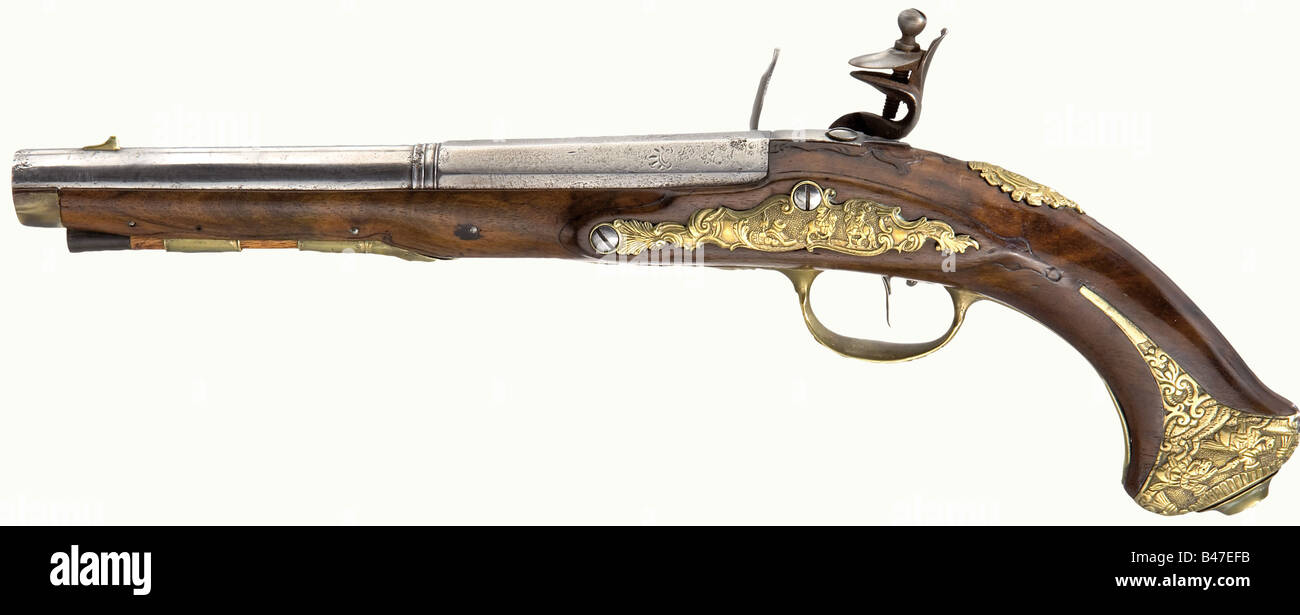 A pair of flintlock pistols, Thaddäus Poltz, Karlsbad, circa 1770. Two-stage barrels, octagonal breech section then round after a baluster with smooth bores in 14.5 mm calibre with brass front sights, and remnants of floral decoration on the breeches. The reconverted flintlocks have bevelled edges, and the lockplates are signed, 'Thaddäus Poltz a Carlsbad' Walnut stocks (crack on one forearm), with fish tail butts and horn nosecaps. The brass furniture bears remnants of fire gilding and is richly decorated with trophies, riders, and cavalry battle scenes in rel, Stock Photo