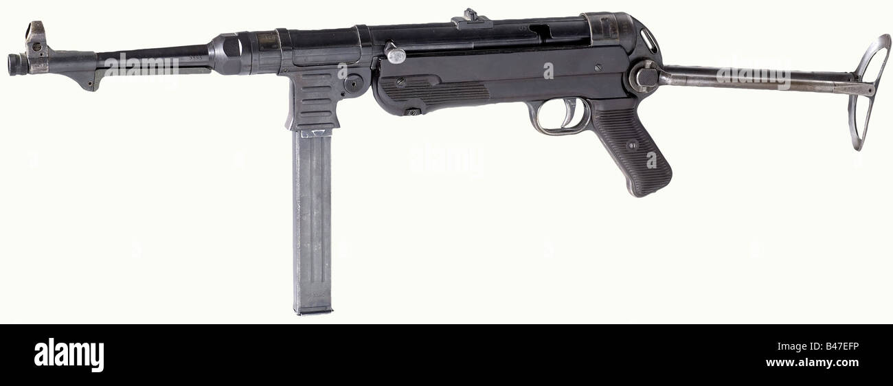A submachine gun model 40 (MP 40), code 'ayf 41', calibre 9 mm Parabellum, no. 5185. No matching numbers. Bright bore. 32 rounds. Produced by Erma at Erfurt in 1941. On the housing marked 'MP 40 / ayf / 41'. Several WaA acceptance marks. Shady and spotty finish, partially somewhat brown patinated, light patches on grip and shoulder rest. No rust at all. Stock and grip panels made of black-brown bakelite, undamaged except for a few scratches. Blued magazine marked 'M.P.38 u.40', code 'kur' with acceptance 'WaA815' for Steyr-Daimler-Puch, Graz. Very nice and attr, Stock Photo