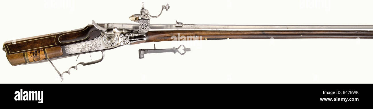A German wheellock rifle, Georg Grosser, circa 1680. Octagonal, lightly swamped barrel with seven-groove rifling in 13 mm calibre. Dovetailed brass front sight and folding, cut iron, rear sight. 'Georg Grosser' engraved on the breech. Wheellock with chiselled floral decoration and a semi-interior wheel. There is a seated Mars with martial trophies on the engraved lock plate. Double set trigger with an engraved iron trigger guard. Walnut stock with a patch box, horn nose cap, and ramrod thimbles of bone and horn. The cheek piece bears an inlaid bone plate engrav, Stock Photo