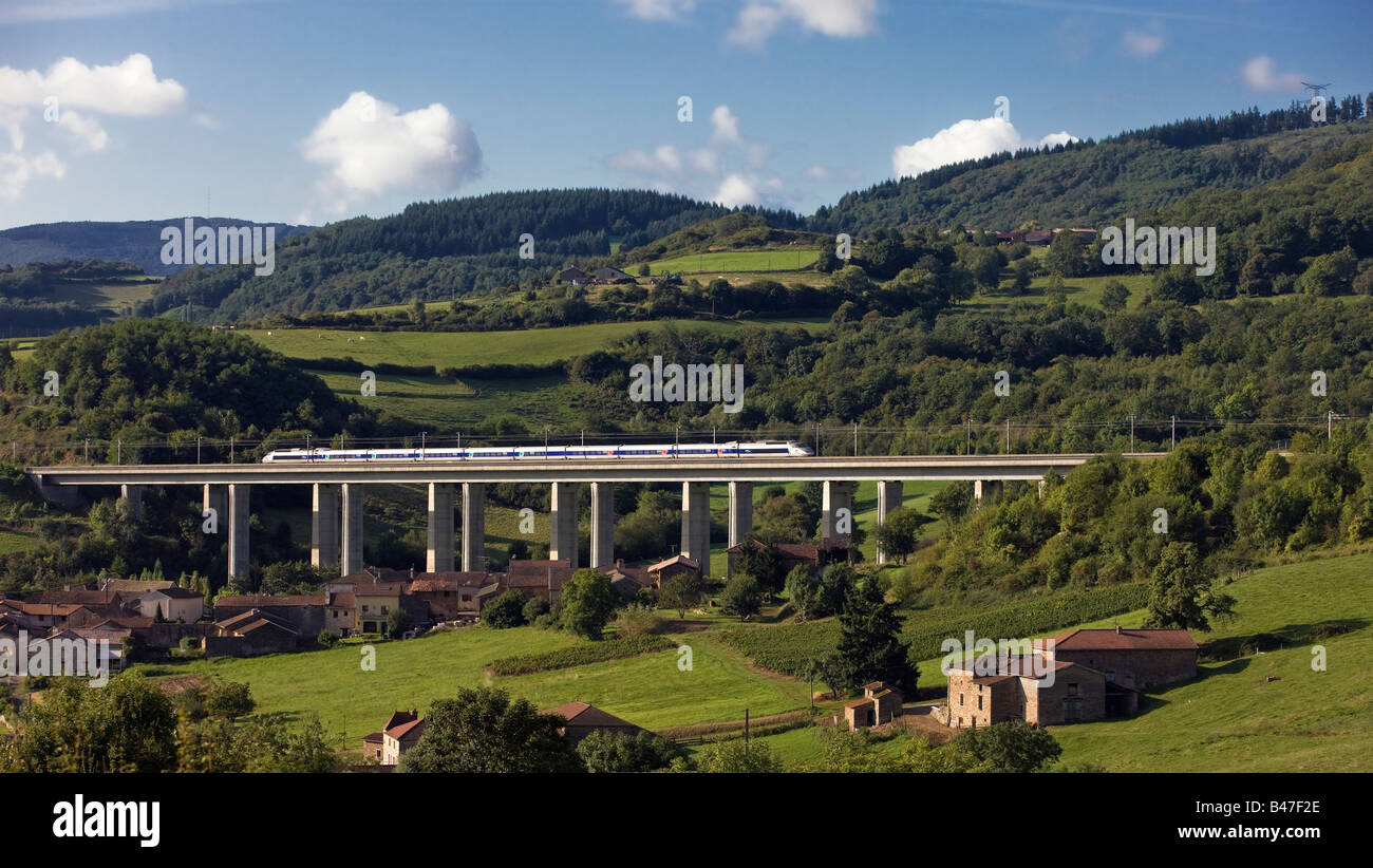 A French high-speed train, or TGV, crosses a bridge in the Burgundy countryside of France Stock Photo