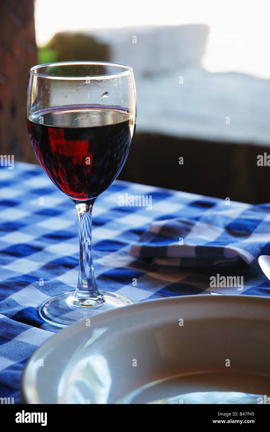 Glass of red wine on tablecloth Stock Photo Alamy