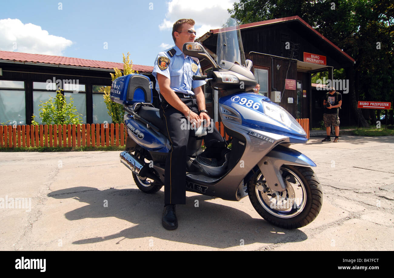 Polish municipal police officer on Romet RXL50 scooter Stock Photo - Alamy