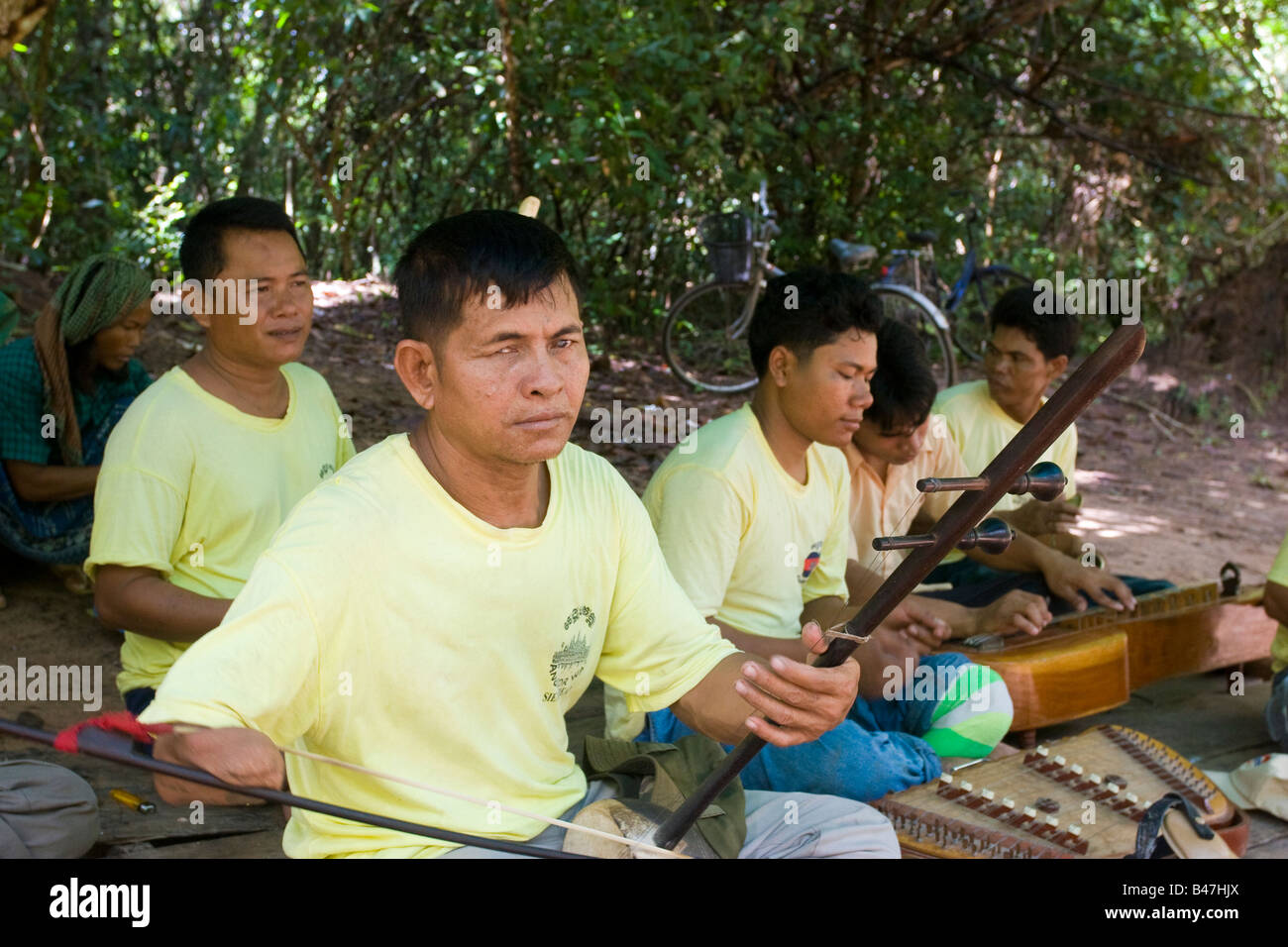 Landmine and war casualties play traditional Cambodian music for tourists outside an Angkor temple, Ta Prohm Cambodia Stock Photo