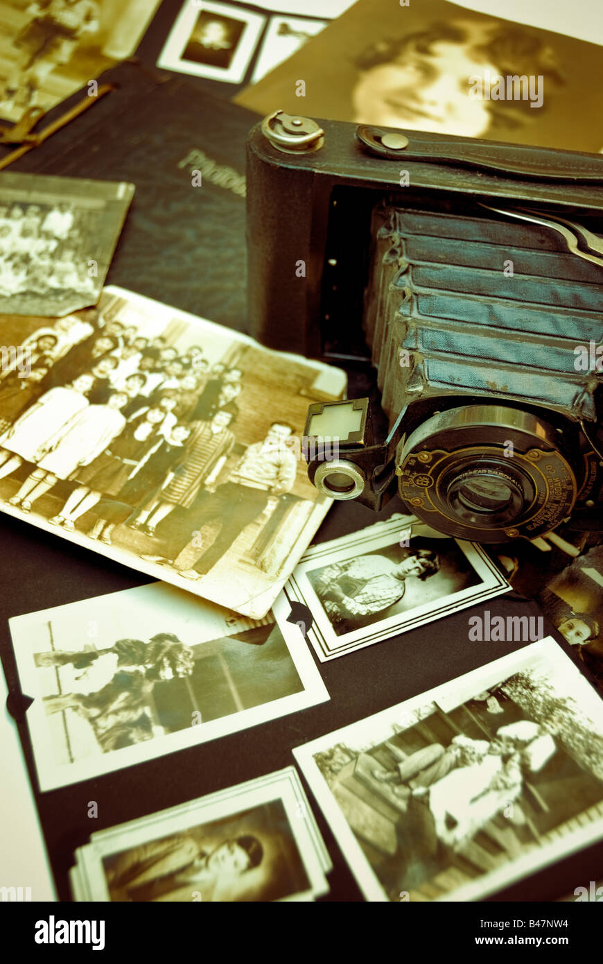 An antique Eastman Kodak Brownie camera and vintage family and class photographs create a nostalgic feeling. Stock Photo