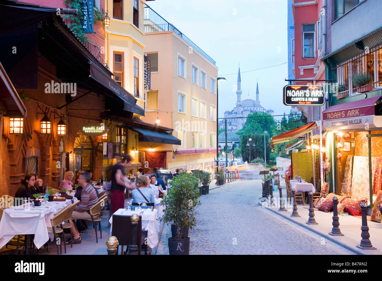 Turkey Istanbul pavement restaurants and cafes with the blue mosque behind Stock Photo