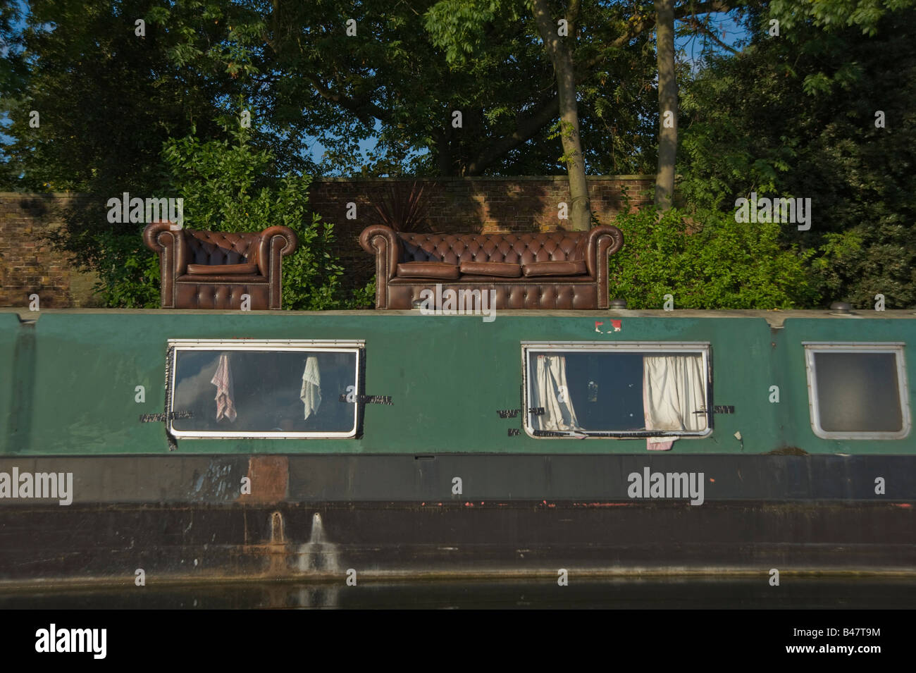 A sofa and settee on top of a house boat on the Grand Union canal West
