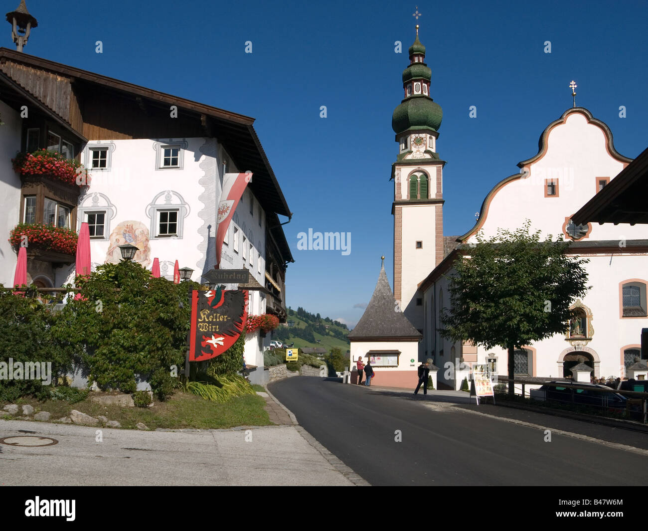 Village church and the Kellerwirt hotel once a 12th Century monastry in Oberau Austria Stock Photo
