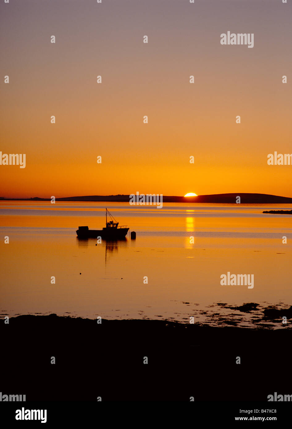 dh St Marys Bay HOLM ORKNEY Sunset over Scapa Flow fishing creel boat tranquil scotland island sun setting sea uk Stock Photo