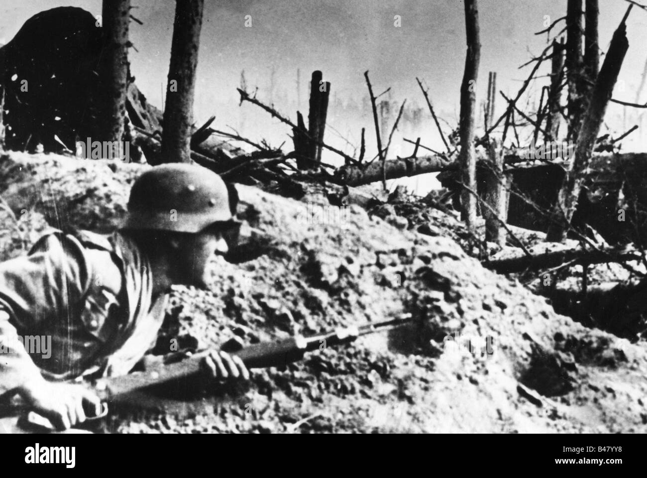 events, Second World War / WWII, Russia 1942 / 1943, German soldier taking cover in a destroyed forrest, 1942, Eastern Front, Soviet Union, USSR, 20th century, historic, historical, Wehrmacht, steel helmet, Karabiner 98k, 98, carbine, rifle, 1940s, people, Stock Photo