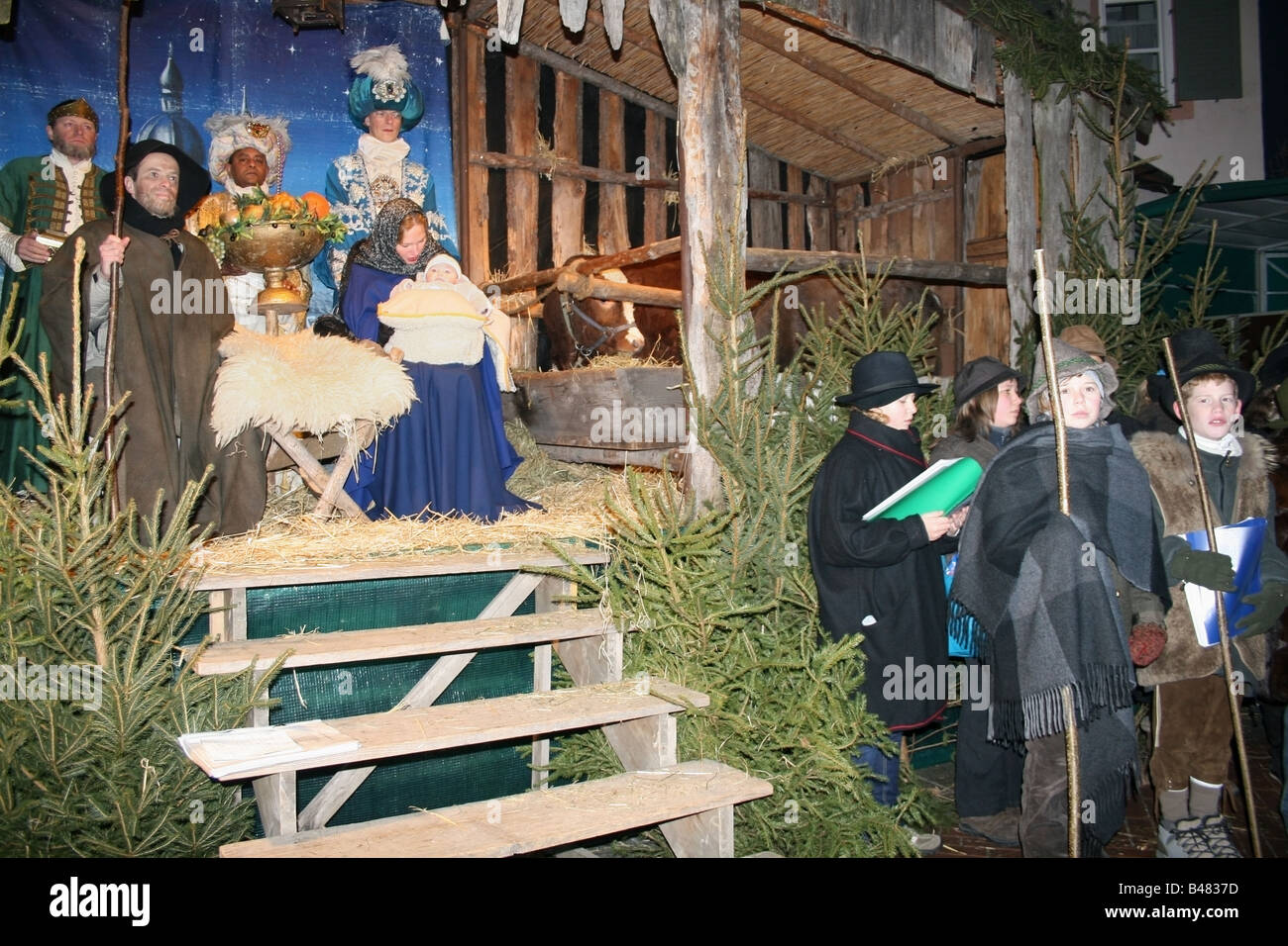 Nativity stand acting out the birth of Jesus in a manger with real people , Munich , Germany Stock Photo