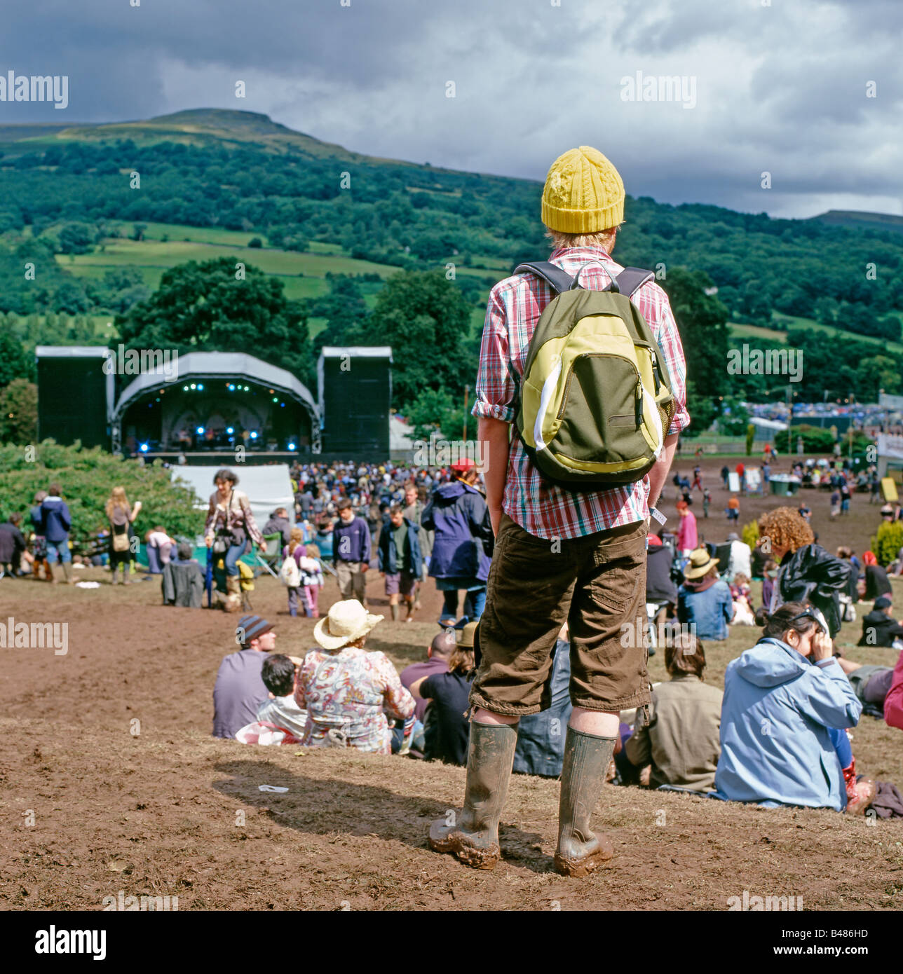 Hippie man with a yellow hat and rucksack in the audience at the Green Man Festival at Glanusk near Abergavenny in Wales UK  KATHY DEWITT Stock Photo