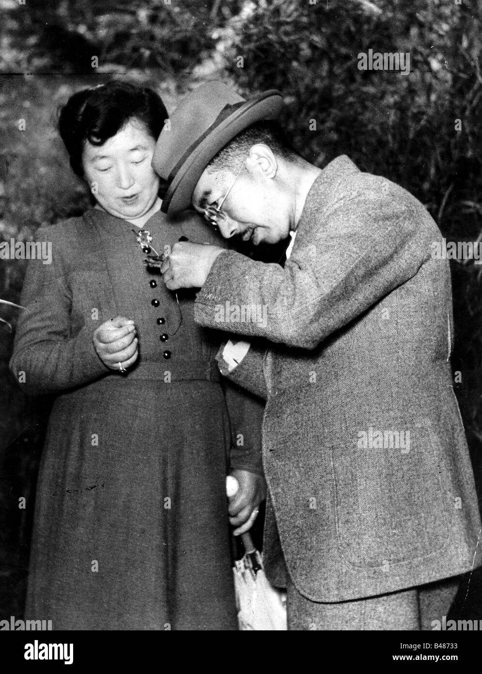 Hirohito, 29.4.1909 - 7.1.1989, Emperor of Japan, half length, with his wife Nagako, looking at plant, garden of Imperial Palace, early 1950s, Stock Photo