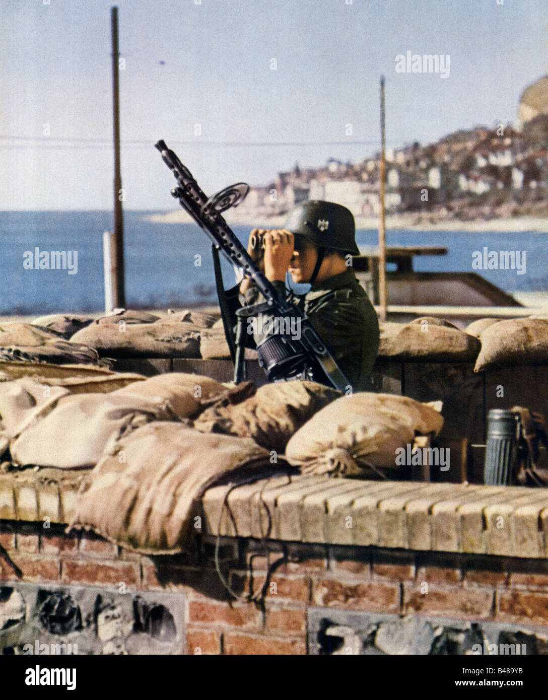 Wehrmacht Anti Aircraft Duty German lookout with MG 34 machine gun on duty by the sea during WW II Stock Photo
