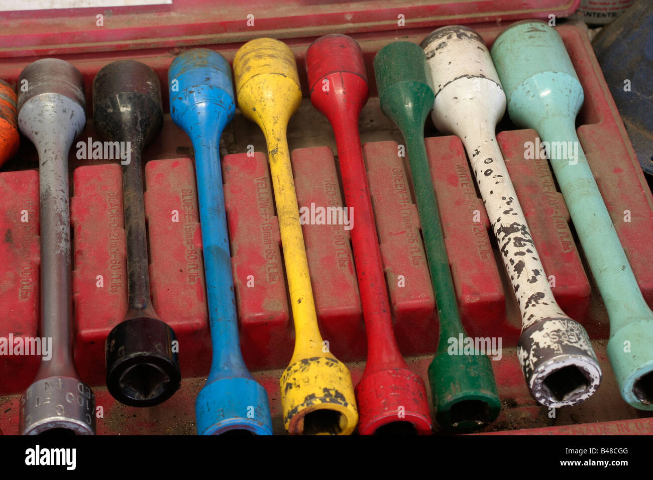Colour coded tyre irons in an auto repair shop Stock Photo Alamy