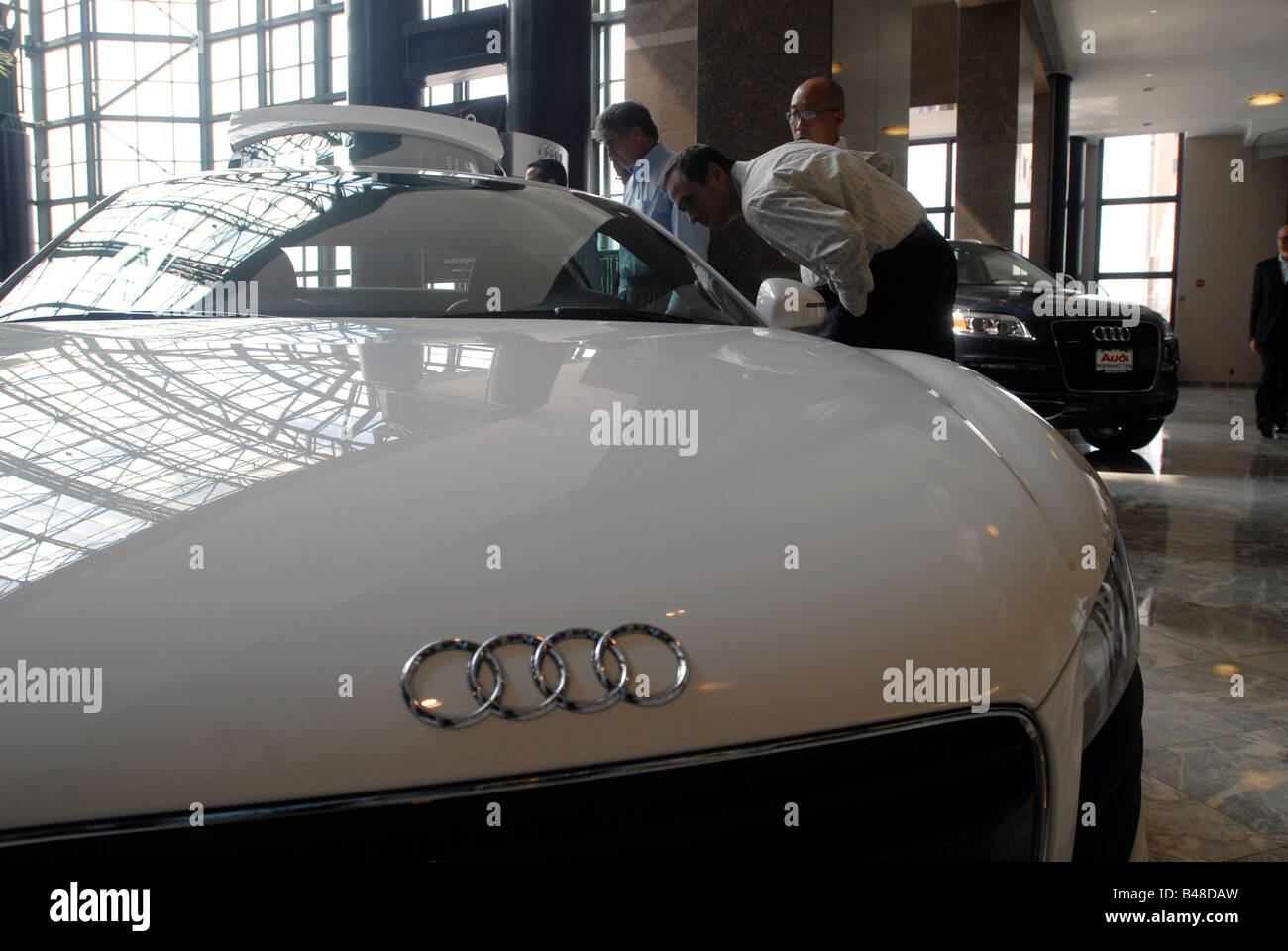 Visitors examine an Audi luxury vehicle on display at the World Financial Center New York Motorexpo Stock Photo