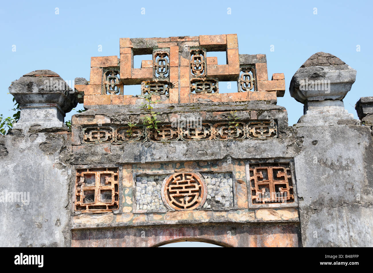 Buddhist symbols on a gate at The Imperial City Hue Vietnam Stock Photo
