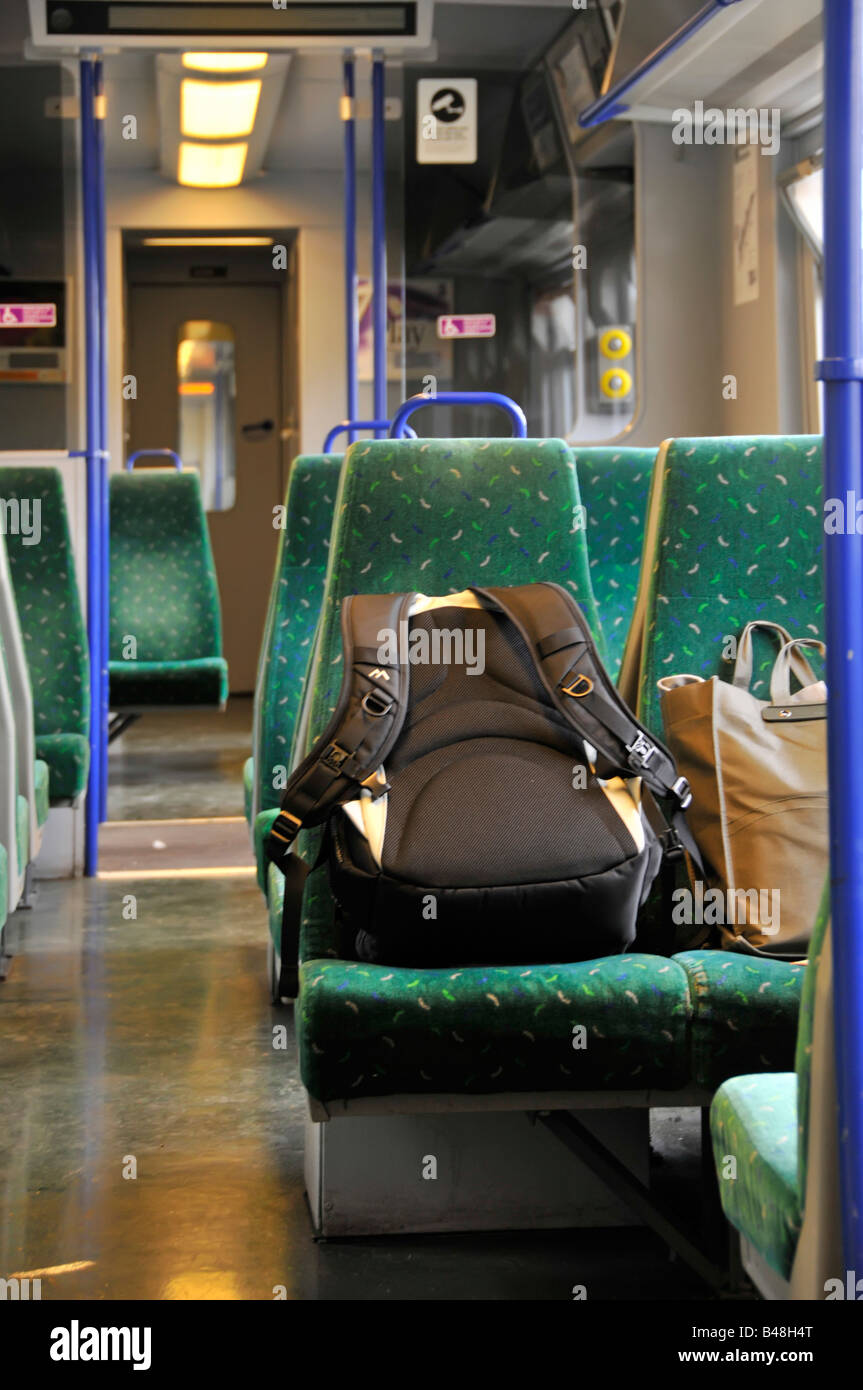 Possible unattended luggage left on a train carriage seat Stock Photo