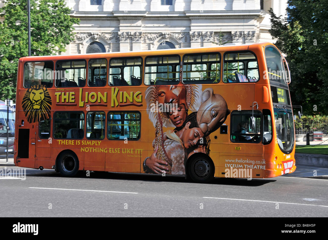 London double decker bus one side covered with colourful advertising graphics for the Lion King musical stage show at the Lyceum Theatre England UK Stock Photo