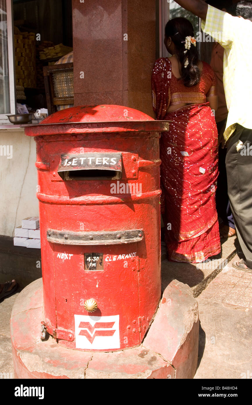 A postbox in Mysore, India. The red post box bears the symbol of India Post. Stock Photo