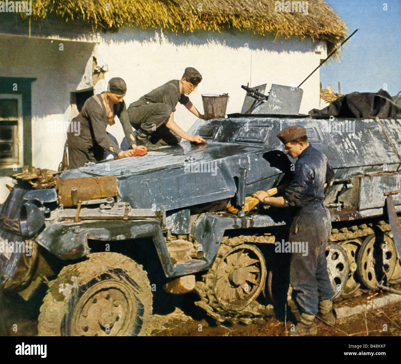 Wehrmacht Cleaning the Half Track Zugkraftwagon armoured personel carrier on the Eastern Front early in the Russian campaign Stock Photo