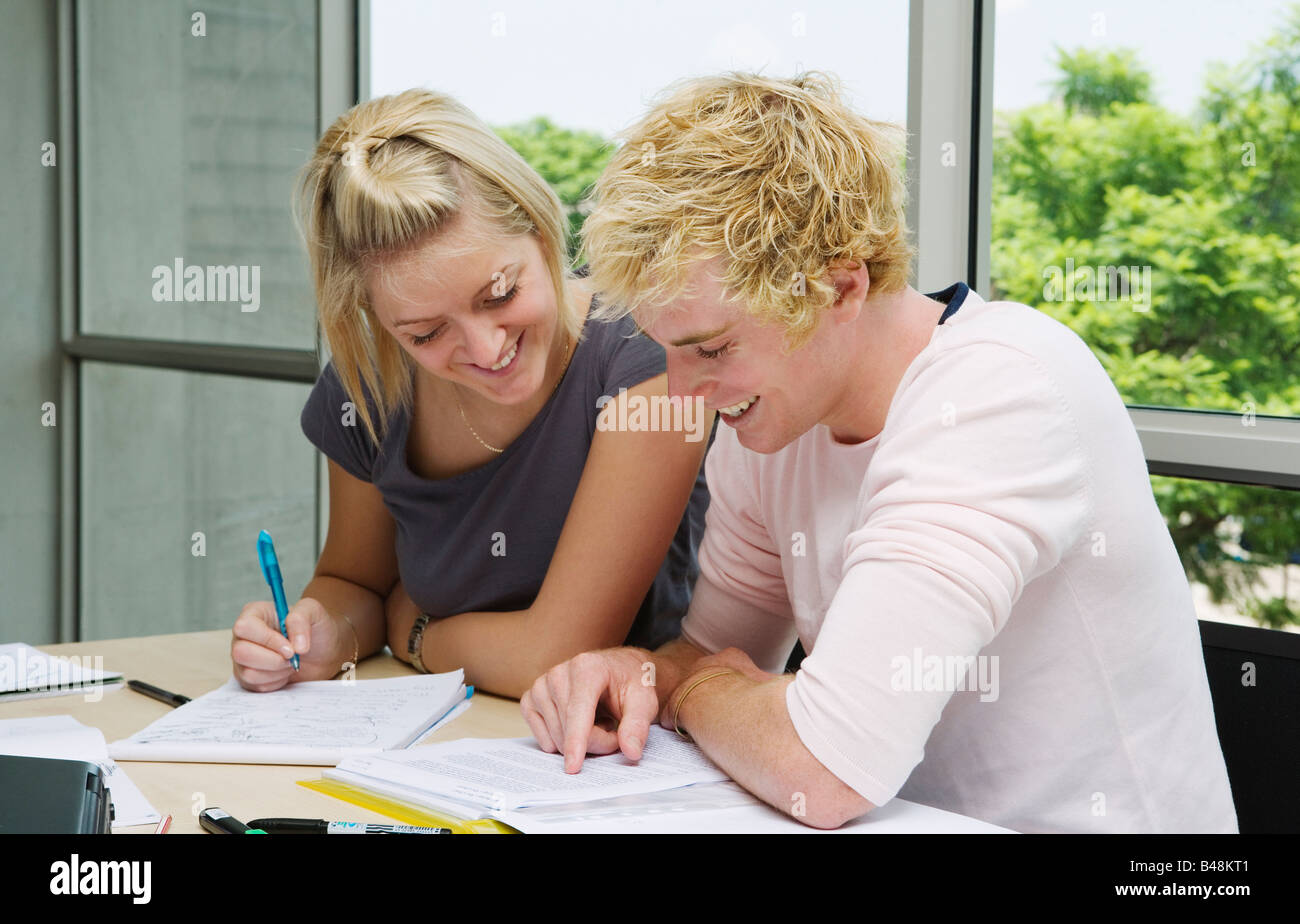 students sitting at table working together Stock Photo
