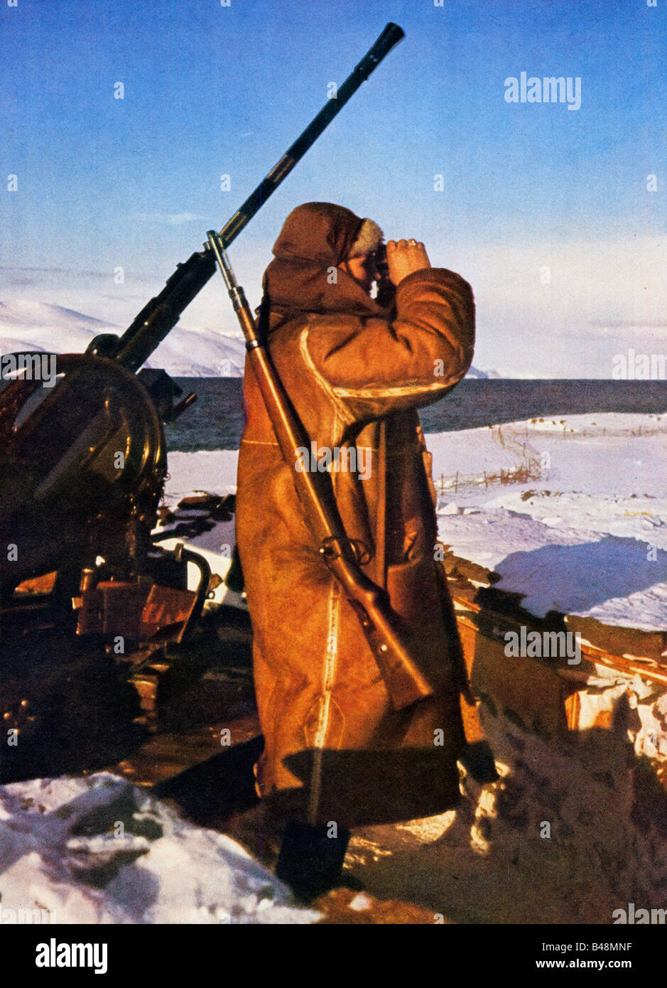 Wehrmacht Arctic Ack Ack German anti aircraft gun emplacement in Norway gunner lookout over the snow Stock Photo