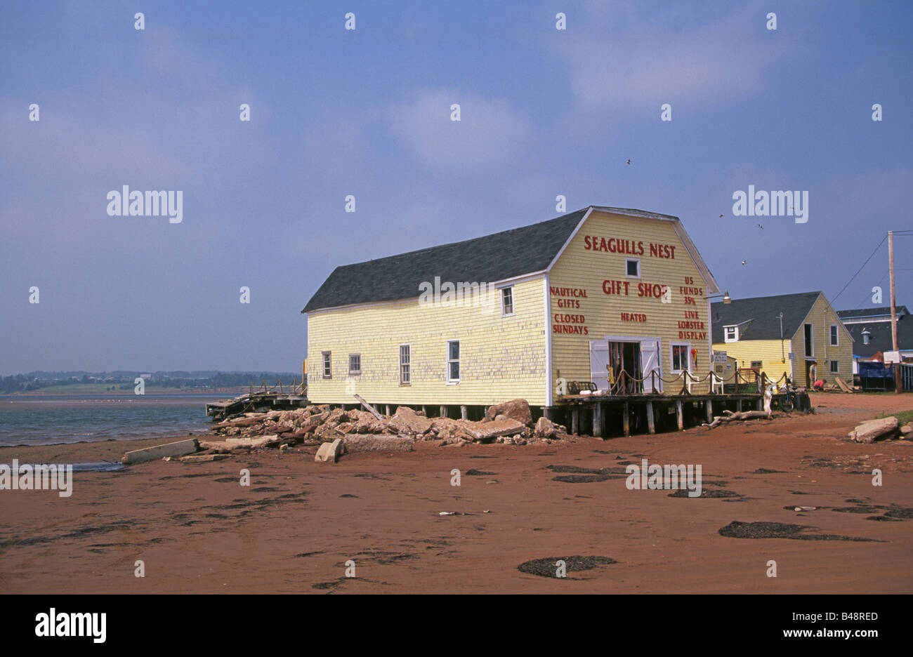 A tiny colorful fishing village at low tide on the PEI coast, Prince Edward Island Canada Stock