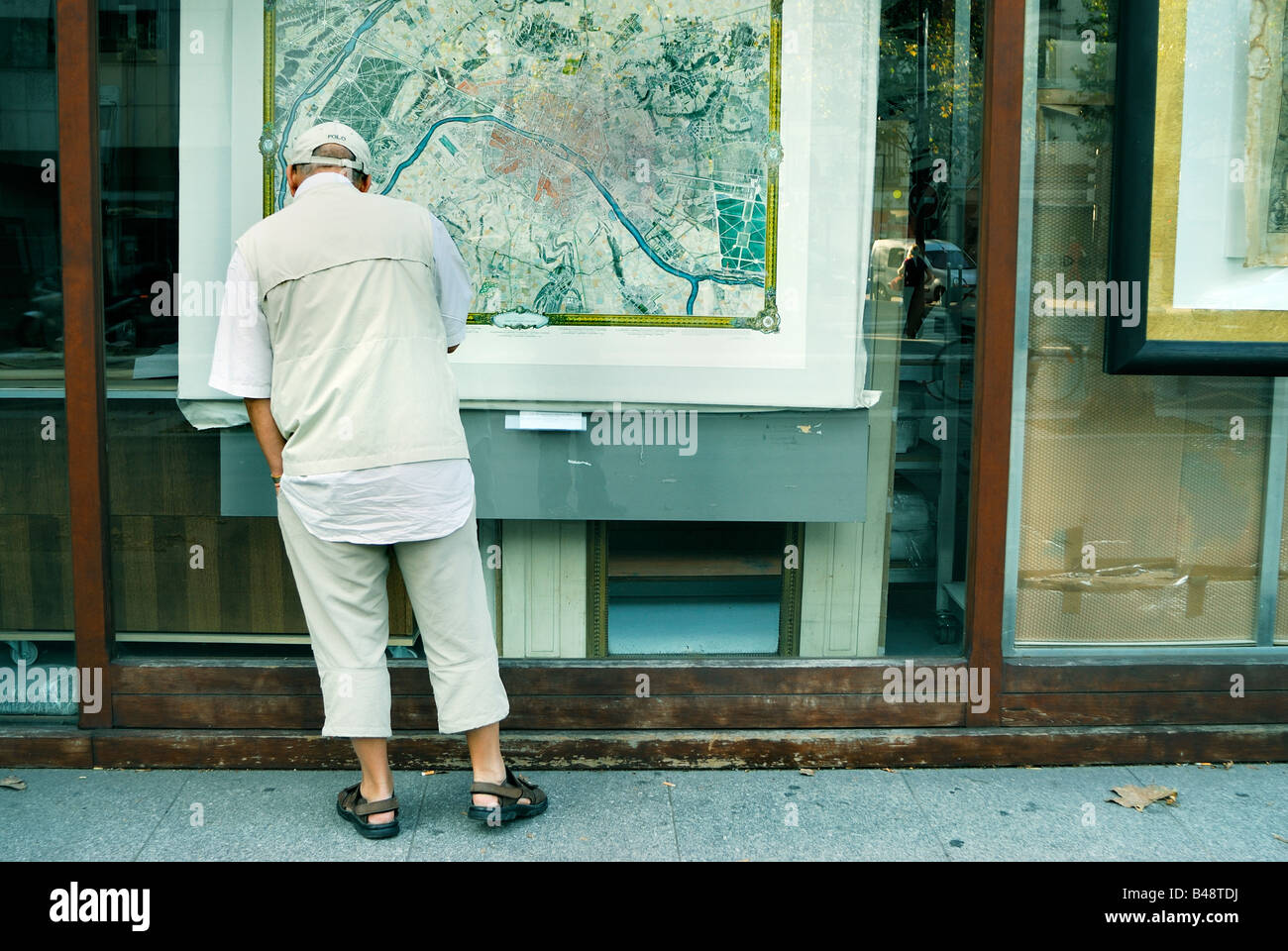 Paris France, Shopping Man Window shopping Looking at Old Map of Paris in Shop Window, Viaduc des Arts Stock Photo