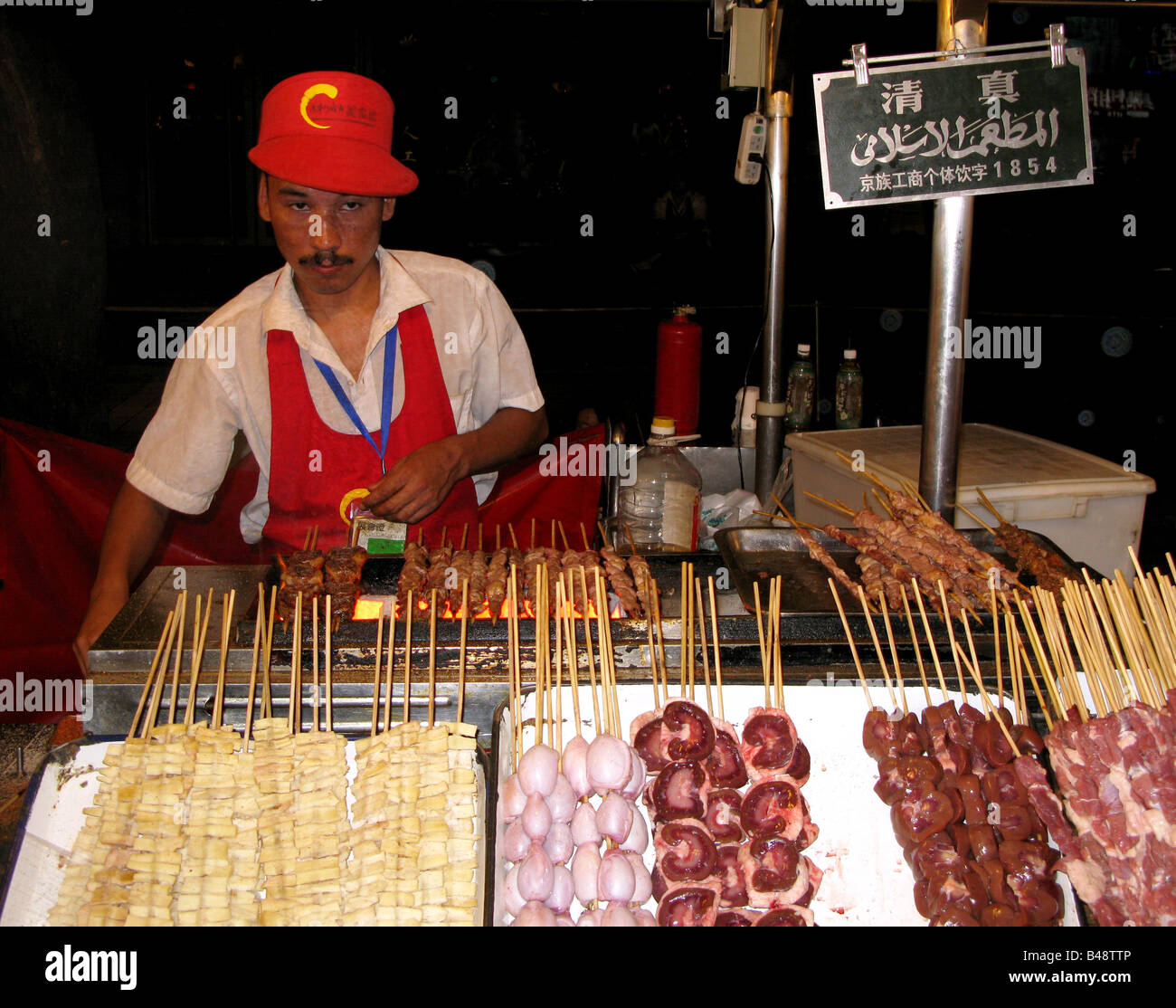 A worker on the Donghuamen Night food street Market in Beijing China Stock Photo