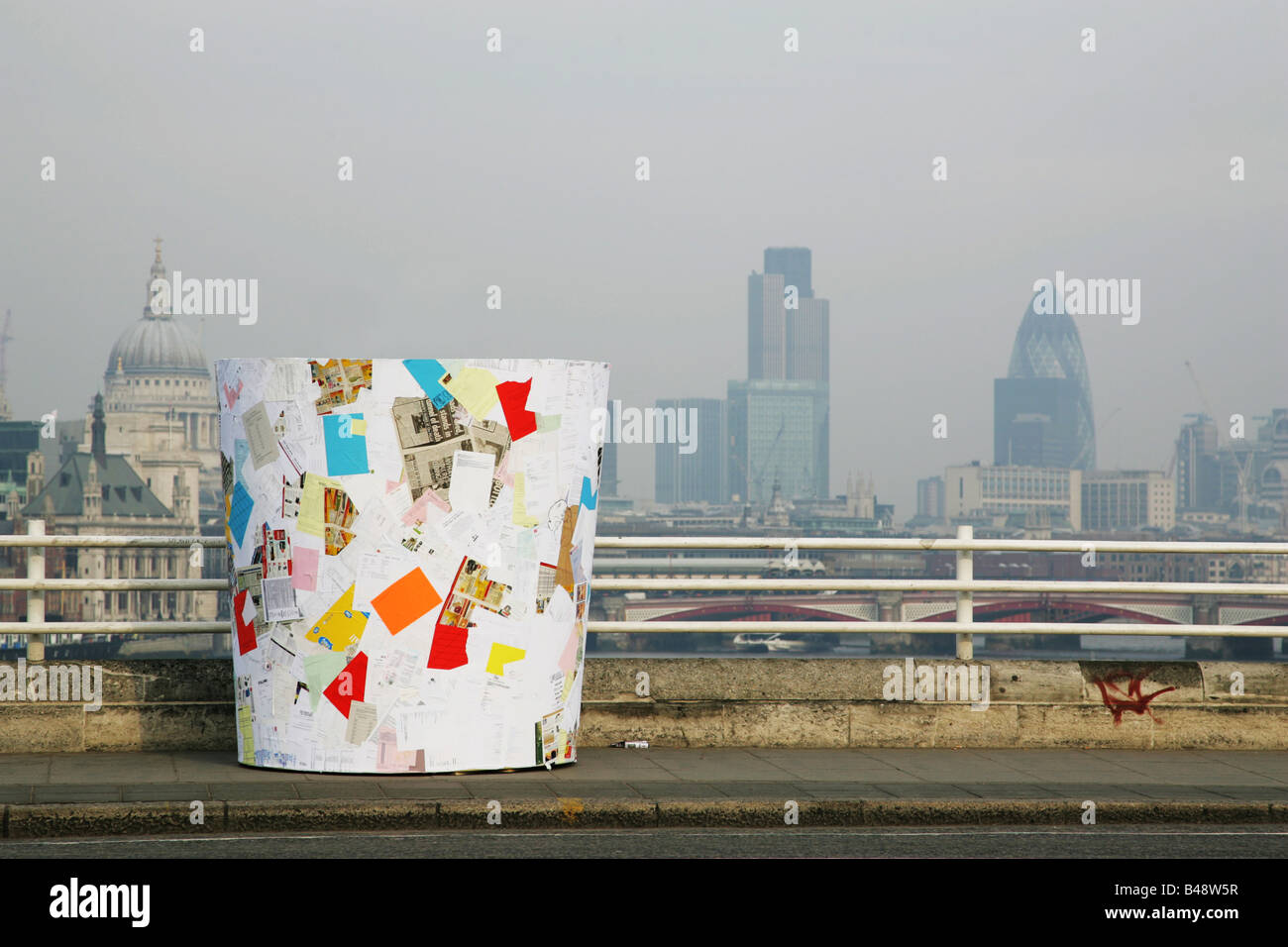 a large fake bin made from the same amount of waste paper that an average London office worker uses placed on Waterloo Bridge Stock Photo