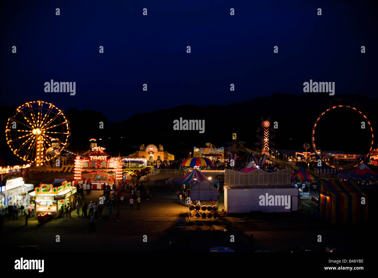 The amusement park at the Nephi, Utah rodeo are lit up at night Stock