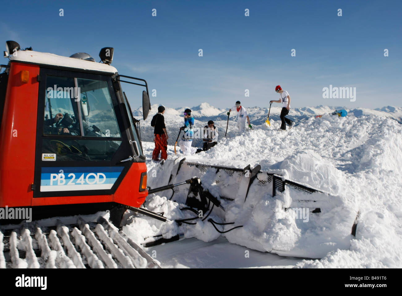 snow cat ploughing snow to build a snowboard jump Stock Photo Alamy