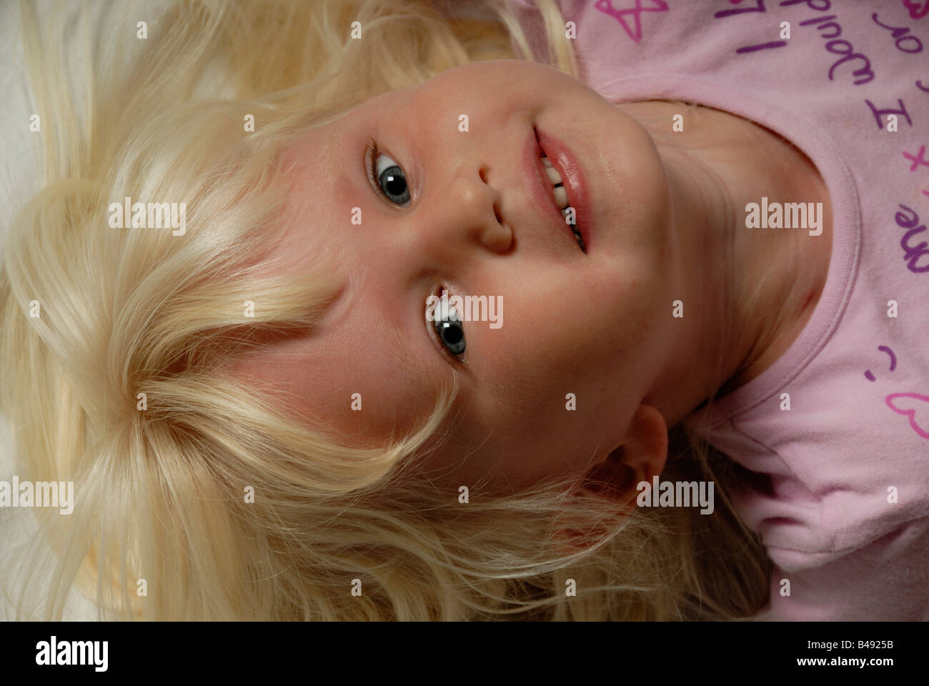 Stock photo of a portrait of a blond haried blue eyed three year old child Stock Photo