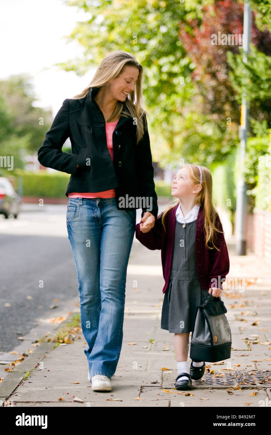 Mother and daughter walking to school Stock Photo Alamy