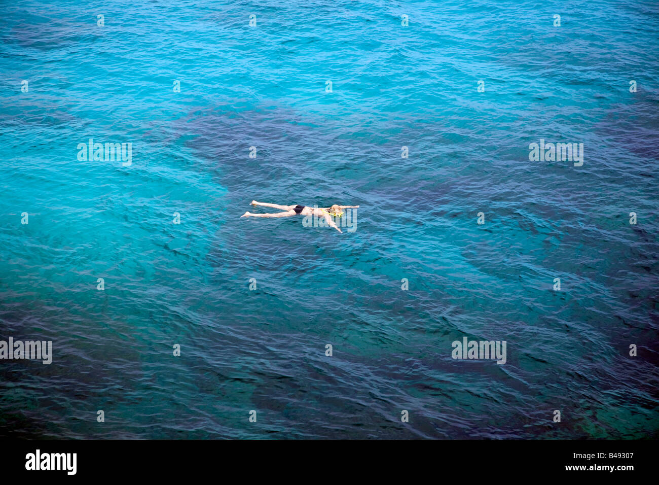 A single snorkeler off Nissi Beach. A sheltered sandy beach close to Agia Napa which attracts thousands of tourists each year. Stock Photo